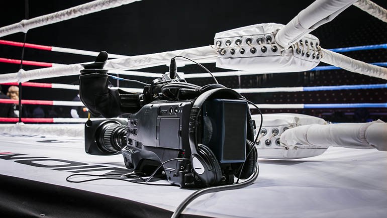 professional camcorder stands on corner ring for mixed martial arts. live broadcast competition in MMA and Boxing
